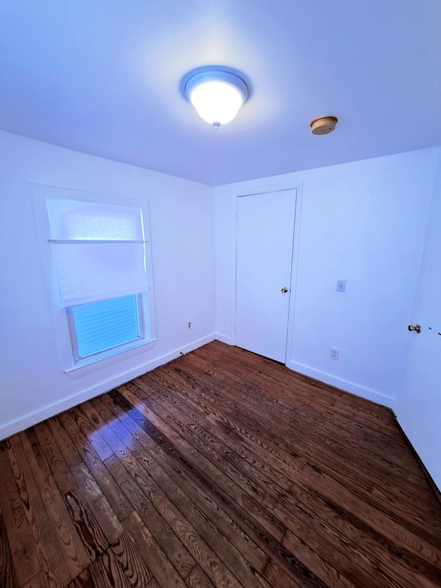 unfurnished room featuring dark hardwood / wood-style flooring