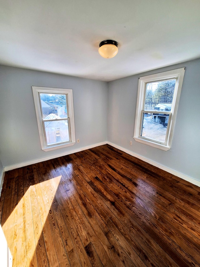 spare room with hardwood / wood-style flooring