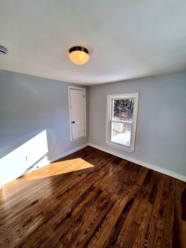 spare room featuring wood-type flooring