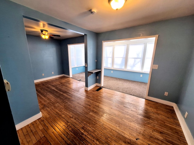 empty room with hardwood / wood-style flooring and ceiling fan