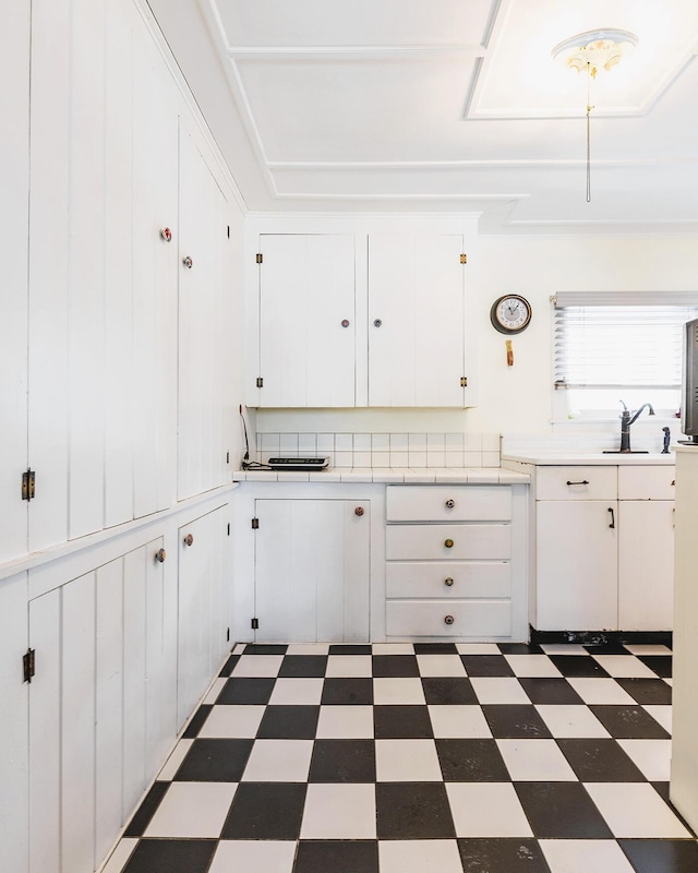 kitchen with white cabinetry and sink