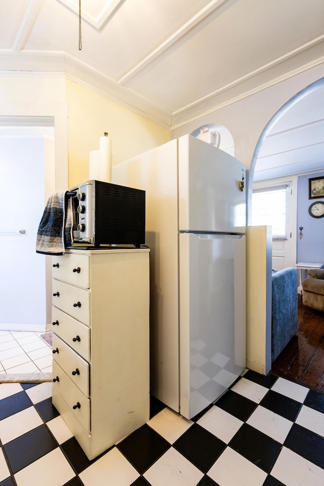 kitchen with white cabinetry and white fridge