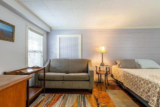 bedroom featuring dark hardwood / wood-style flooring and crown molding