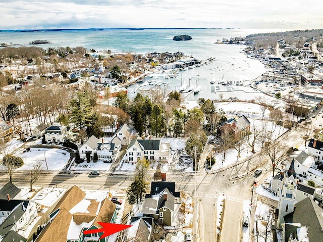 snowy aerial view featuring a water view