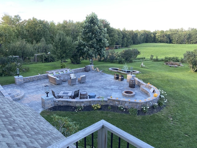 view of yard featuring a fire pit and a patio