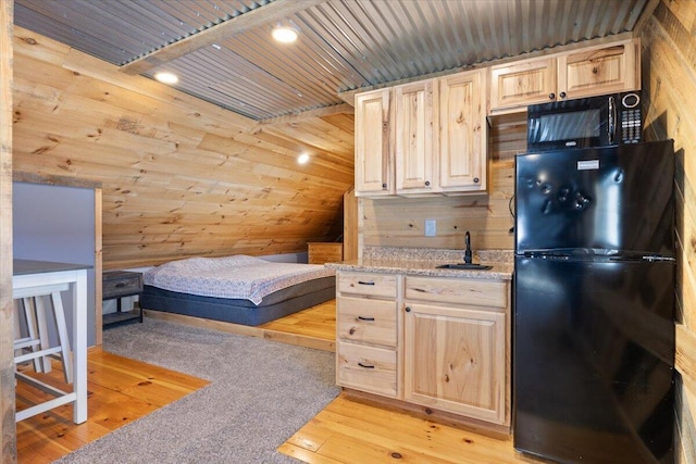 bedroom featuring wooden ceiling, light wood-style flooring, wooden walls, and freestanding refrigerator