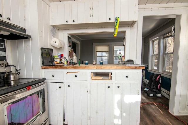 kitchen featuring wooden walls, stainless steel range with electric stovetop, dark hardwood / wood-style flooring, and white cabinets