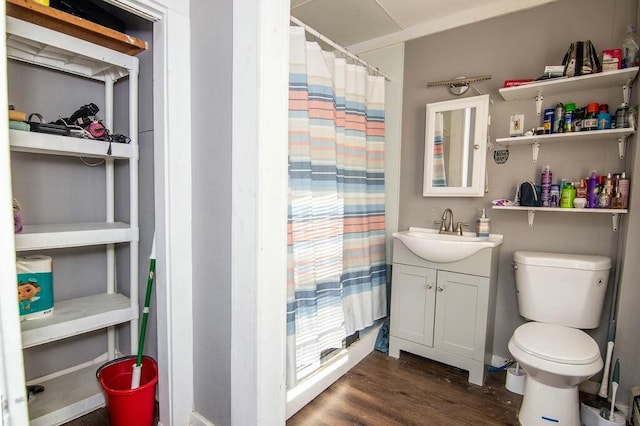 bathroom with vanity, toilet, and hardwood / wood-style floors