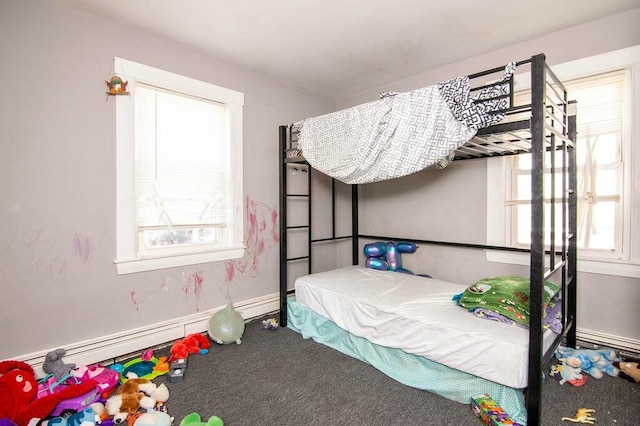 carpeted bedroom with a baseboard radiator