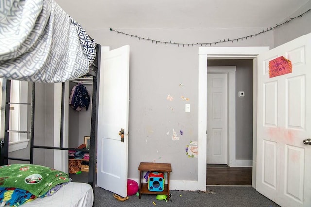 bedroom featuring dark colored carpet