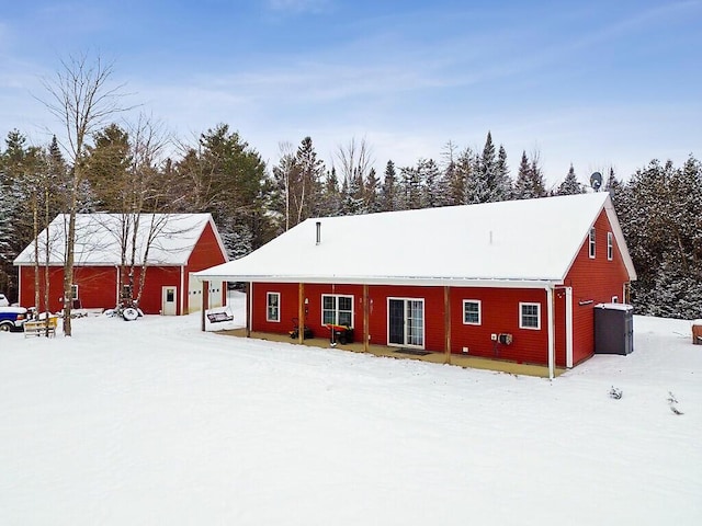 view of snow covered rear of property