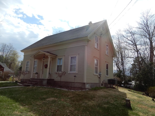 47 High Rd, Cornish, ME 04020 - view of front facade with a chimney, a front yard, and central AC unit