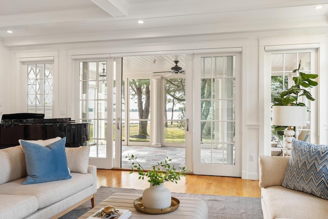sunroom with a wealth of natural light, french doors, and beamed ceiling
