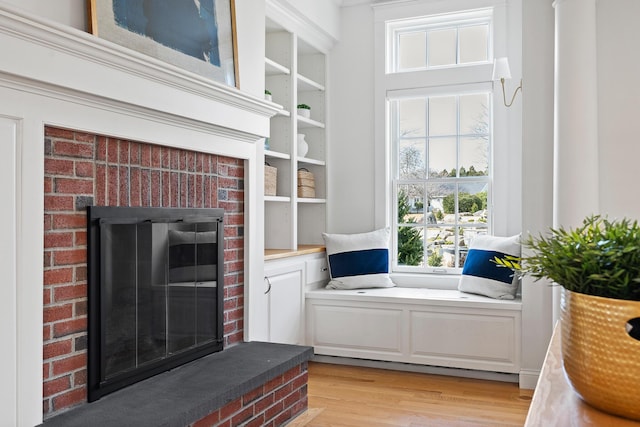 interior space with light wood-type flooring and a fireplace