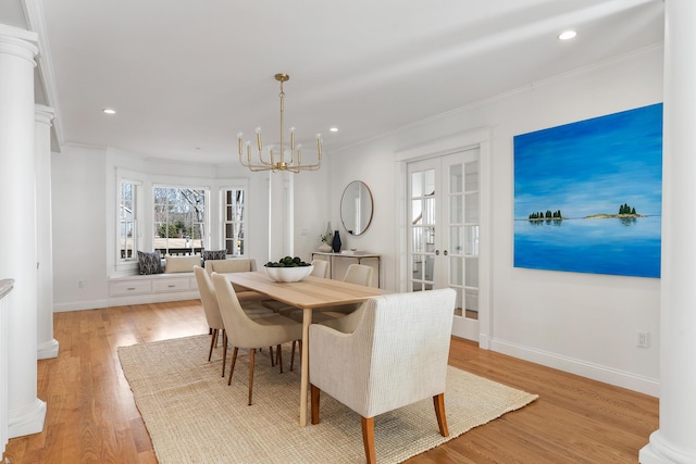 dining space with light wood finished floors, french doors, recessed lighting, a chandelier, and ornamental molding