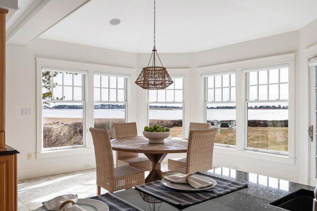 sunroom featuring a chandelier