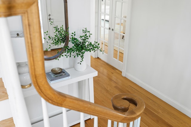 interior space featuring baseboards, french doors, and wood finished floors