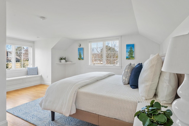 bedroom featuring vaulted ceiling and wood finished floors