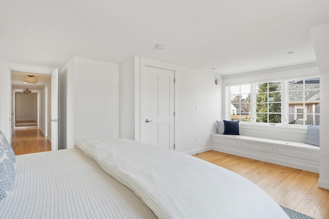 bedroom featuring baseboards and light wood finished floors