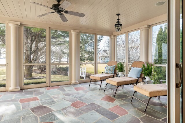 sunroom / solarium with stone finish floor and ornate columns