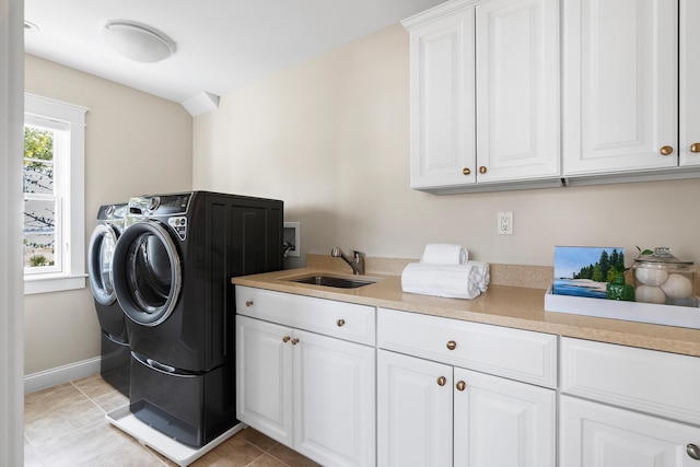 22 Channel Cove Ln, Biddeford, ME 04005 - laundry room featuring cabinet space, washing machine and dryer, light tile patterned floors, and baseboards
