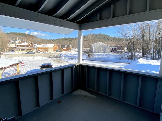 snow covered patio with a balcony