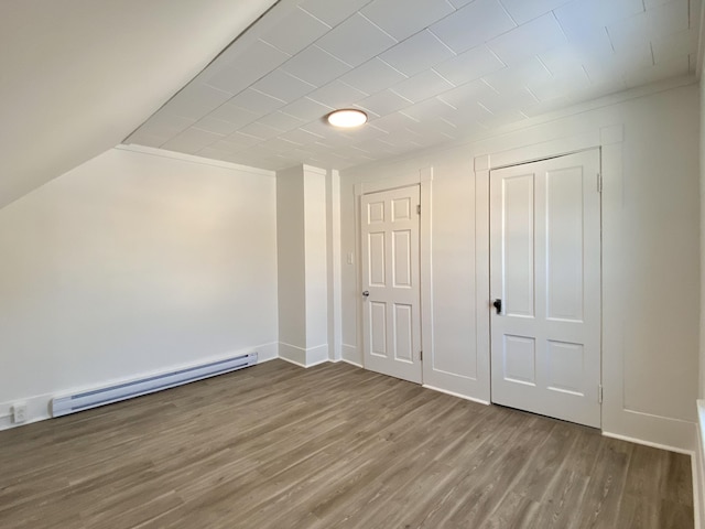 interior space with a baseboard radiator and dark hardwood / wood-style floors