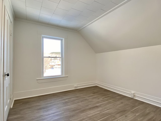 bonus room featuring dark wood-type flooring and vaulted ceiling