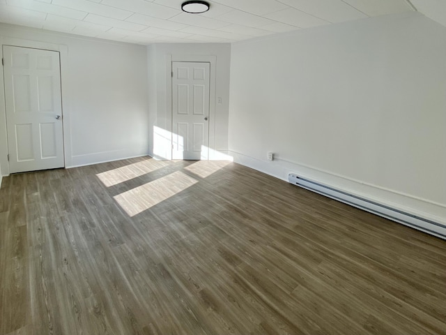 empty room with a baseboard heating unit and wood-type flooring