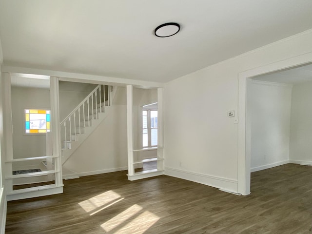 unfurnished living room with dark hardwood / wood-style flooring