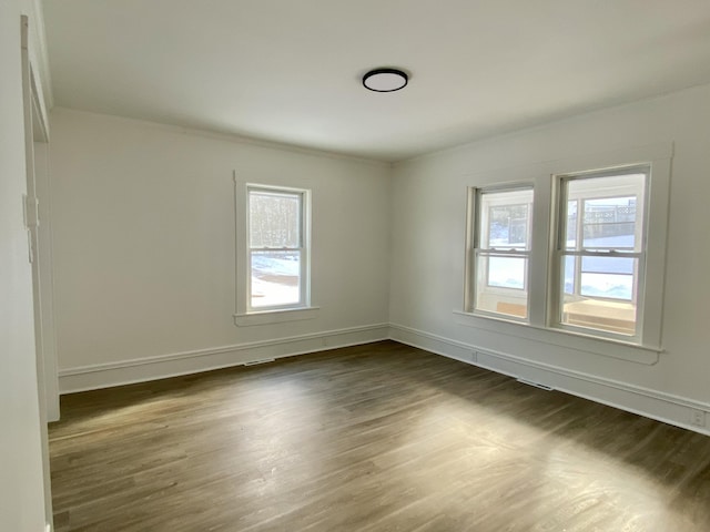 spare room featuring dark wood-type flooring