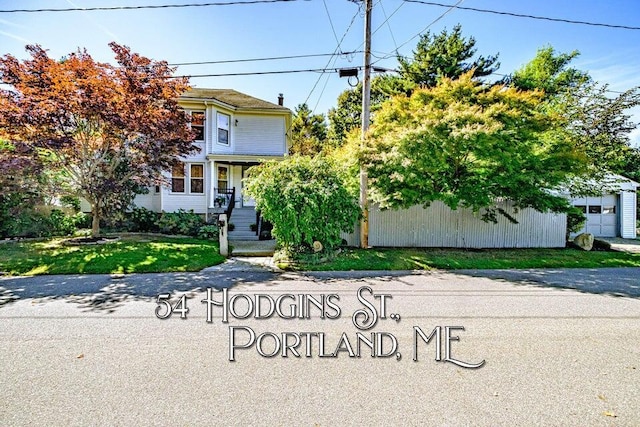 obstructed view of property with a front yard