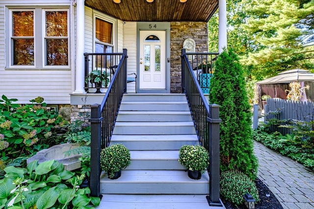 view of exterior entry with a porch