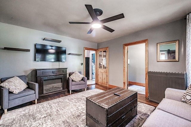 living room featuring ceiling fan and hardwood / wood-style floors