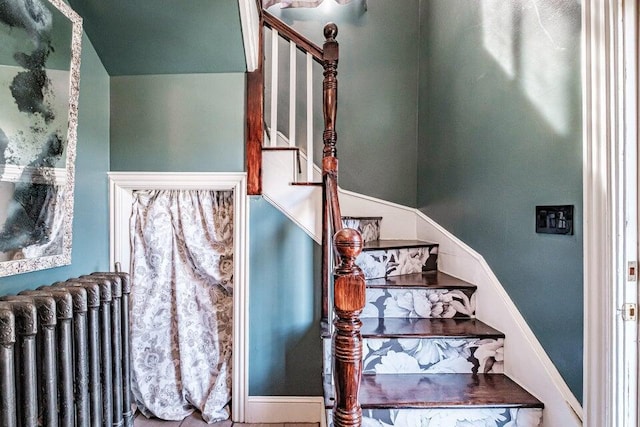 stairway featuring radiator heating unit