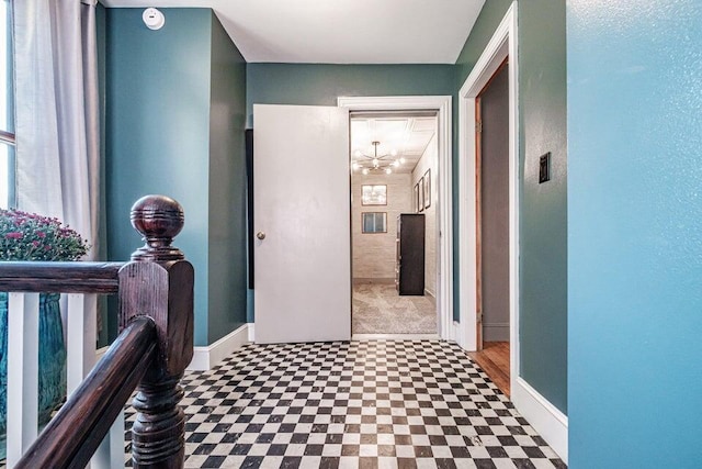 hallway with an inviting chandelier