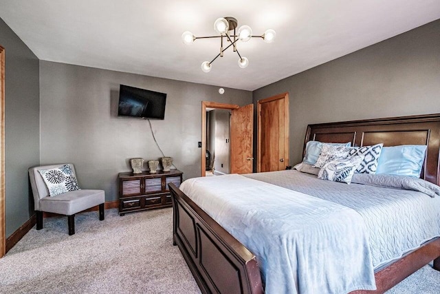 carpeted bedroom featuring a chandelier