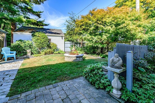 view of yard with a patio area and an outdoor fire pit