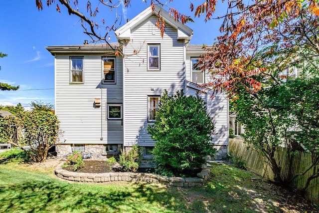 rear view of house with a yard