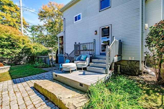 back of property featuring a wooden deck and a patio area