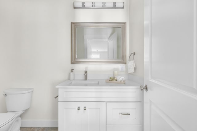 bathroom with toilet and vanity