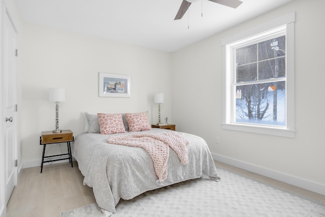 bedroom with ceiling fan and light hardwood / wood-style floors