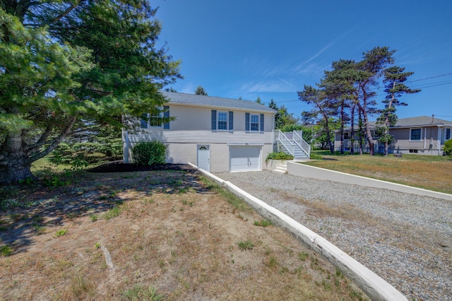 3 Sea Breeze Ave, Biddeford, ME 04005 - ranch-style home featuring dirt driveway, a garage, and stairs