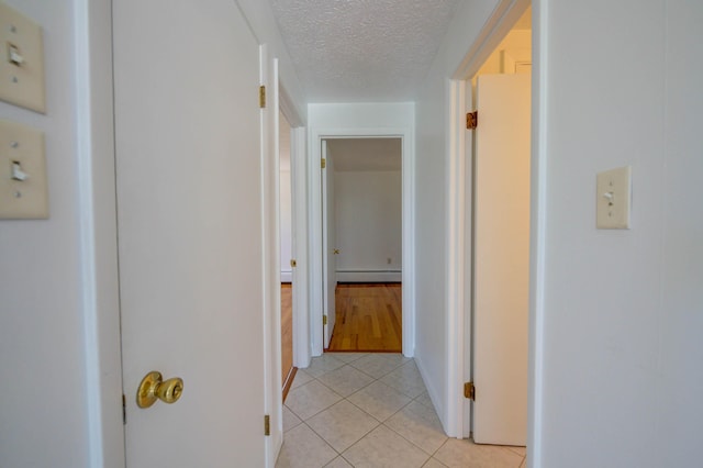3 Sea Breeze Ave, Biddeford, ME 04005 - corridor featuring baseboard heating, light tile patterned flooring, and a textured ceiling
