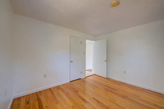 3 Sea Breeze Ave, Biddeford, ME 04005 - unfurnished room featuring a smoke detector, light wood-style floors, and a textured ceiling