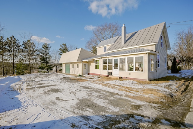 snow covered house with a garage