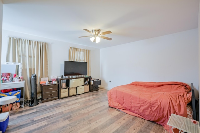 bedroom with ceiling fan and light hardwood / wood-style floors