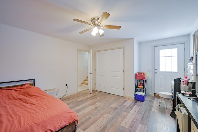 bedroom featuring ceiling fan, light hardwood / wood-style floors, and a closet