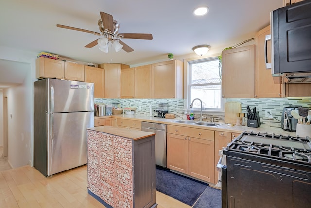 kitchen featuring stainless steel appliances, sink, and light brown cabinets