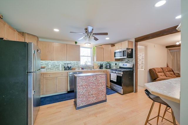 kitchen featuring backsplash, stainless steel appliances, light hardwood / wood-style floors, and light brown cabinets